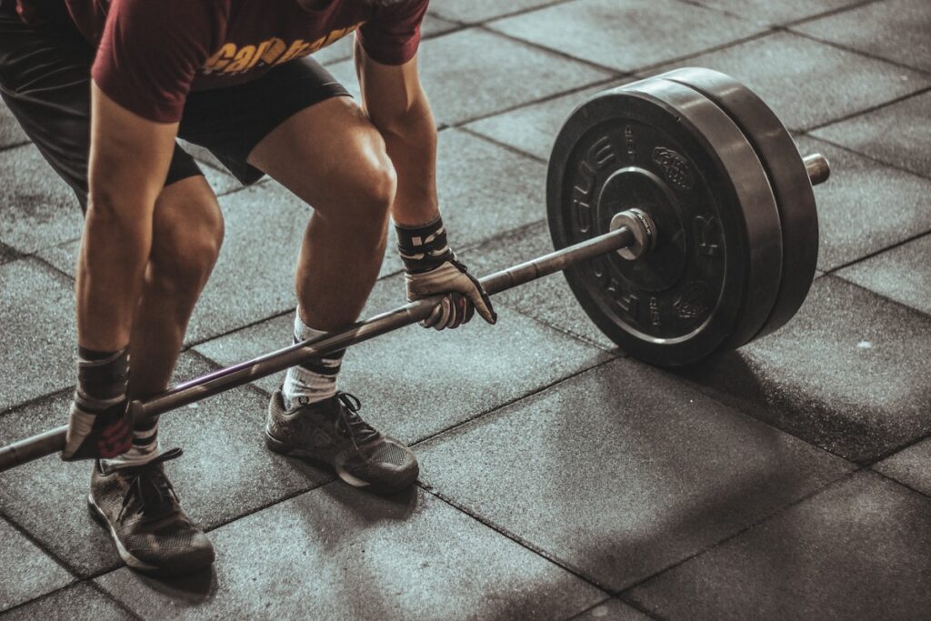 Hands gripping a barbell during strength training session at Rushcutters Bay Park Sydney