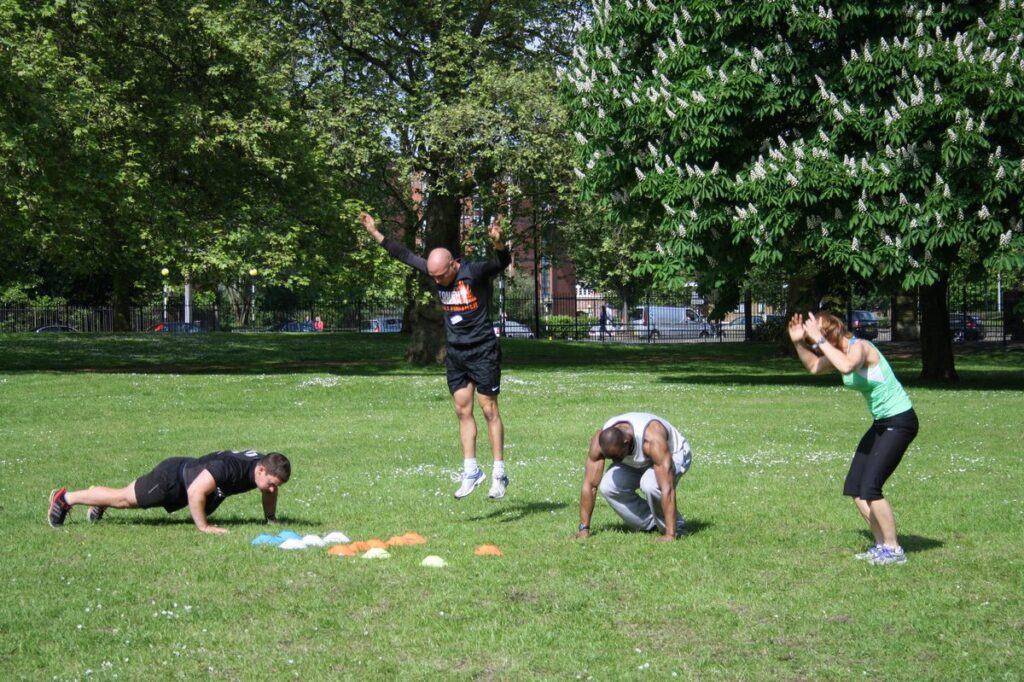 Pre-Natal Training: What's Safe, What's Not, and Why It Matters Group training community with cones set up for outdoor fitness session in Sydney park